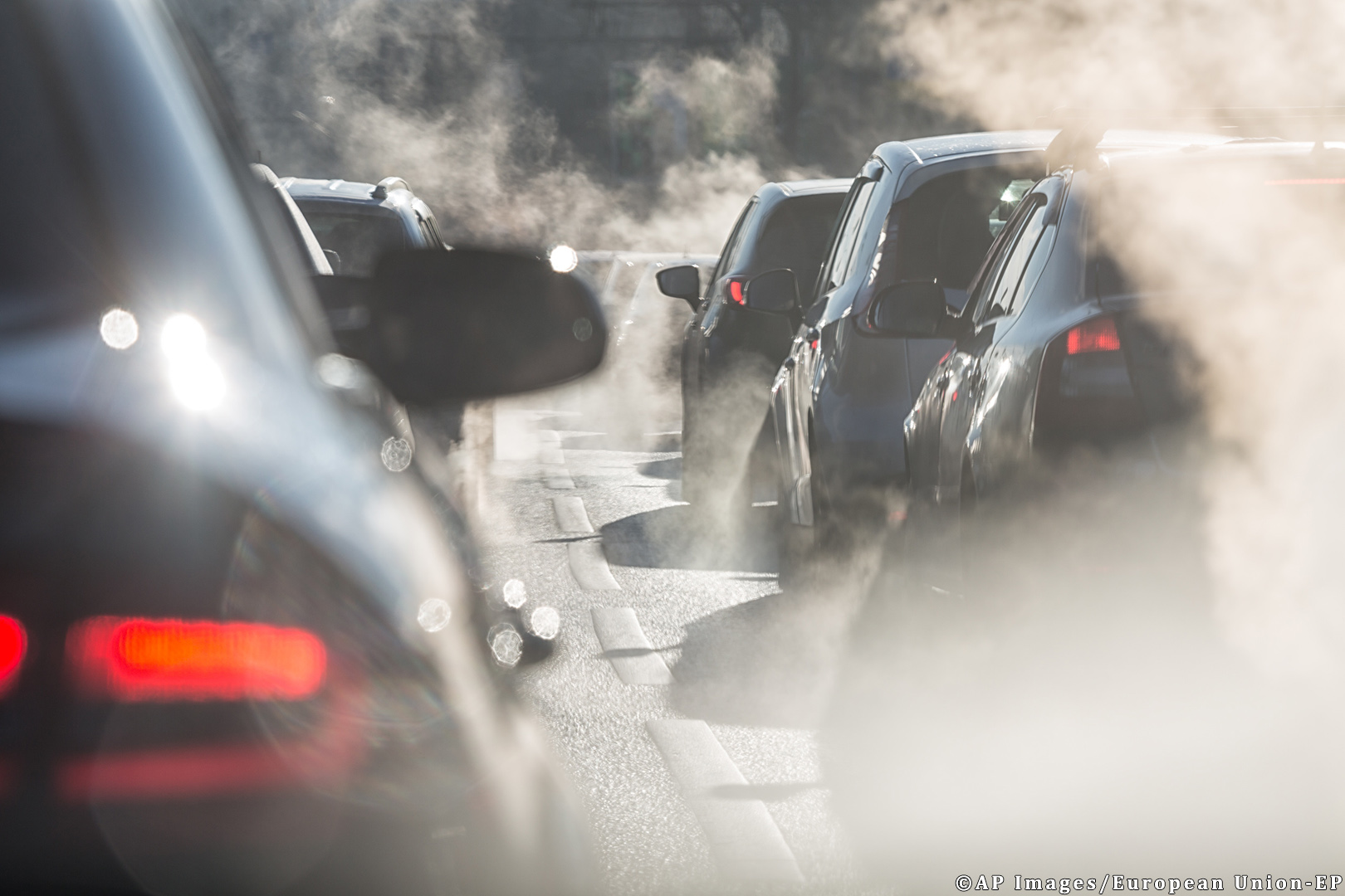 blurred-silhouettes-of-cars-surrounded-by-steam-from-the-exhaust